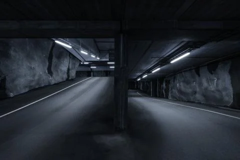 Sci fi looking dark and moody underground parking lot with fluorescent lights Stock Photos