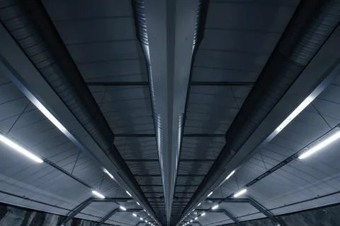 Sci fi looking dark and moody underground parking lot with fluorescent lights Stock Photos