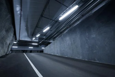 Sci fi looking dark and moody underground parking lot with fluorescent lights Stock Photos