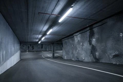 Sci fi looking dark and moody underground parking lot with fluorescent lights Stock Photos