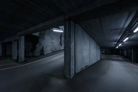 Sci fi looking dark and moody underground parking lot with fluorescent lights Stock Photos