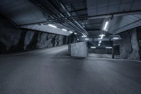 Sci fi looking dark and moody underground parking lot with fluorescent lights Stock Photos