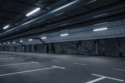 Sci fi looking dark and moody underground parking lot with fluorescent lights Stock Photos