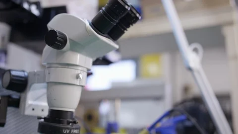 Science and tech tilt down microscope in lab with microchip Video stock 89514522