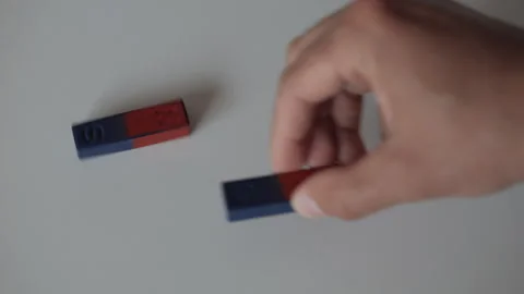 Science Educational Experiment With Magnets. Man Hand Moves Two Magnets Aro.. Video stock 327597687