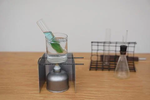 Science experiment about extract chlorophyll by boiling leaf in test tube glass. Stock Photos