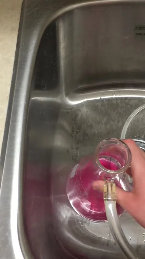 Science Experiment Turning Pink Liquid Purple then Transparent Stock Footage 261347064