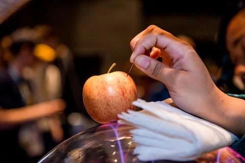 Science experiment using electricity to carve into an apple. Close up view Stock Photos