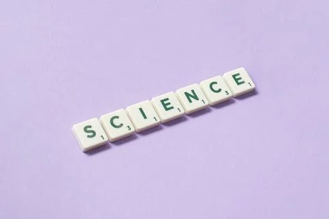 Science formed of scrabble elements on lilac background. Stock Photos