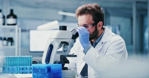 Science, goggles or man in laboratory with microscope, test or examination .. Stock Photos
