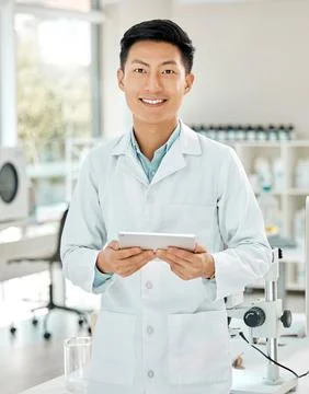 Science has all the answers we seek. Portrait of a young scientist using a Stock Photos