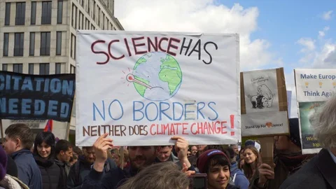 Science has no borders, neither does climate change, March protest sign, Berlin Stock Footage 87451359
