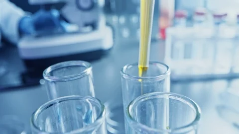 Science Lab: Pipette Dropping Yellow Liquid into Test Tubes, Medical Research Stock Footage 121783213