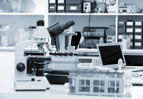 Science laboratory with a microscope, biological material samples and a computer Stock Photos