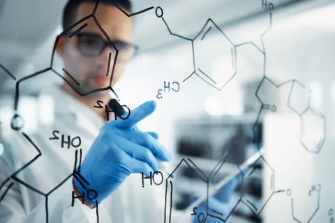 The science man with a plan. Shot of a young scientist solving equations on a Photos