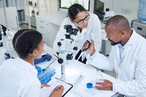Science, microscope and team with pipette in lab, talking and medical resea.. Stock Photos