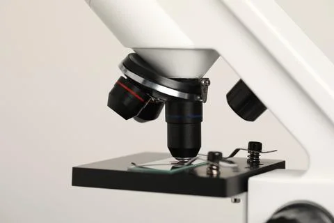 Science. Microscope with glass slide on light grey background, closeup Stock Photos