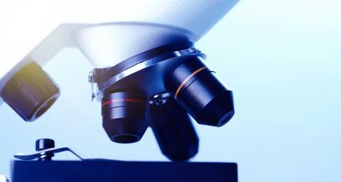 Science. Modern microscope on light blue background, closeup. Space for text Stock Photos