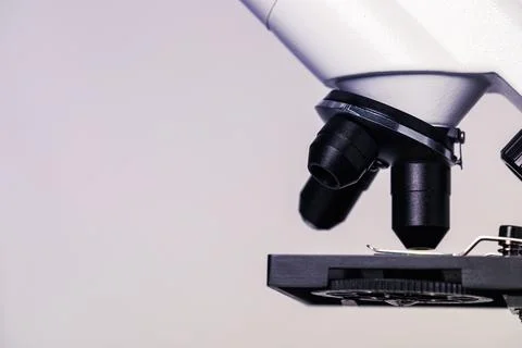 Science. Modern microscope on light grey background, closeup. Space for text Stock Photos
