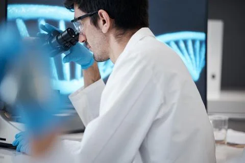 Science, research and microscope with man in laboratory for dna, pharmacy and Foto stock