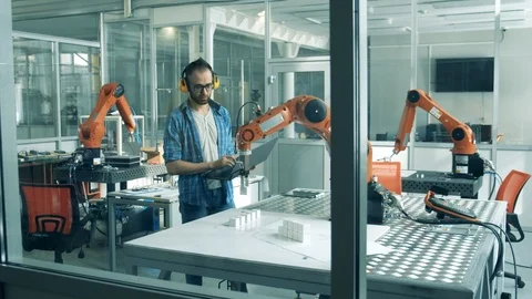 Science student is testing a robotic device in a laboratory Stock Footage 127021259