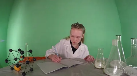 Science student writes in a notebook and studying chemical reagent. 스톡 동영상 59961626