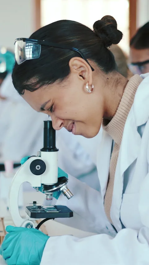 Science, students and girl with microscope in high school, biology class and Stock Footage 332974098