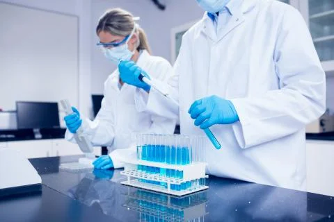 Science students using pipettes to fill test tubes 스톡 사진