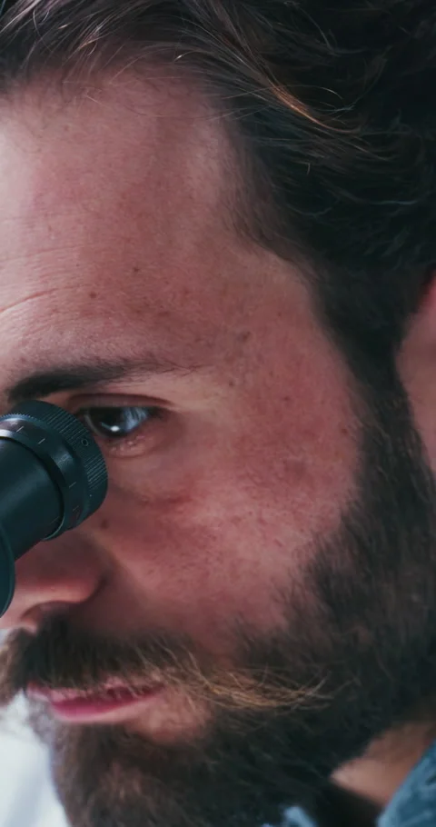 Science, study or man in lab with microscope, analysis or examination in vaccine Stock Footage 331572234