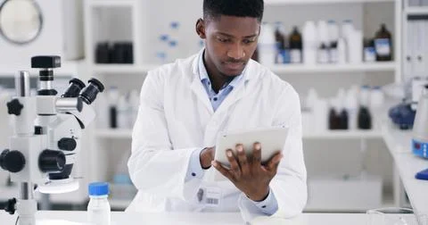 Science, tablet and black man in lab for medical research, medicine study a.. Stock Photos