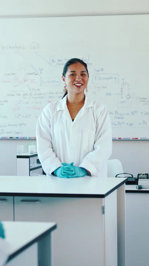 Science, teacher and talk in classroom with lesson, explain physics course or Stock Footage 332894734
