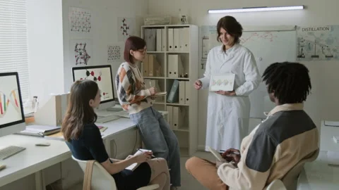 Science Teacher Interacting with her Attentive Students During Chemistry Class Stock Footage 312322822