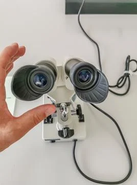 Science theme, view of a black and white microscope and a hand scientist Stock Photos
