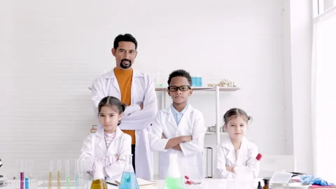Sciense teacher and multiracial students standing with confidence in the sc.. Stock Footage 243655121