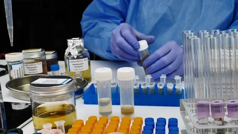 Scientific analysis of wastewater sample in laboratory Stock Footage 129559428