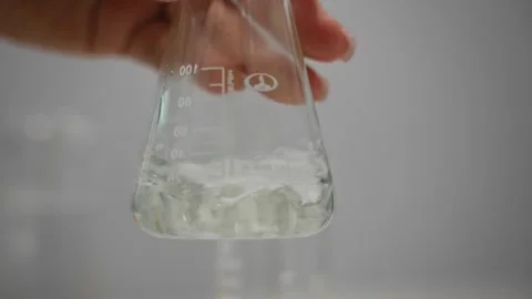 Scientific Demonstration Of Dye Dispersion In Transparent Flask Under Controlled Stock Footage 323799767