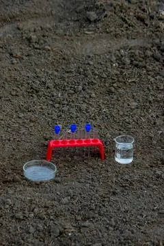 Scientific experiment setup with beaker test tube and blue lights Stock Photos