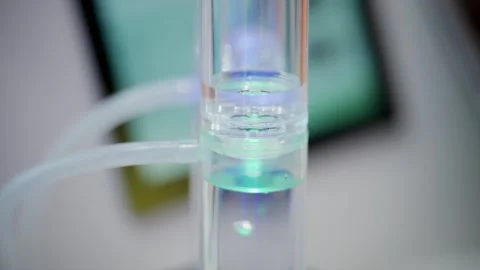 Scientific hydrogen generation experiment showing gas bubbles moving through Stock Footage 335311534
