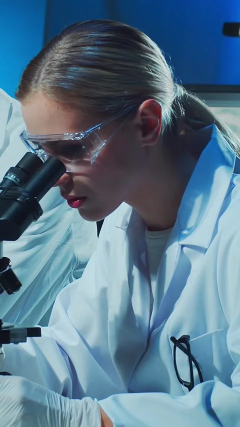Scientific laboratory filled with various research equipment. Scientists are Stock Footage 304489162