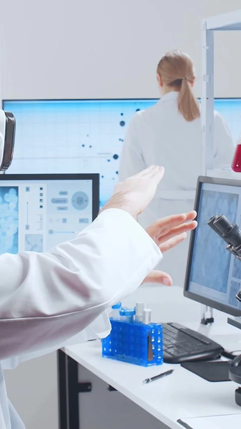 Scientific laboratory filled with various research equipment. Scientists are Stock Footage 304521482