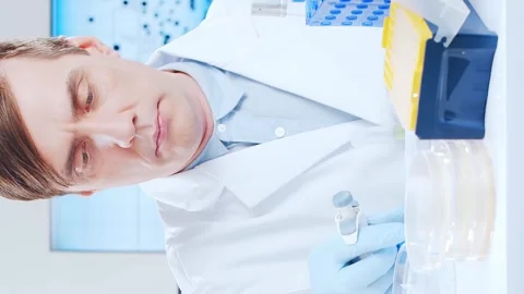 Scientific laboratory filled with various research equipment. Scientists are Stock Footage 308461576