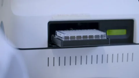 Scientific Laboratory Machine Loading Microtiter Plate into High-Tech Analysis Stock Footage 311418790