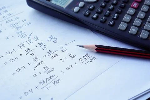 Scientific math workout. sheet paper with solving equation math next to calcu Stock Photos