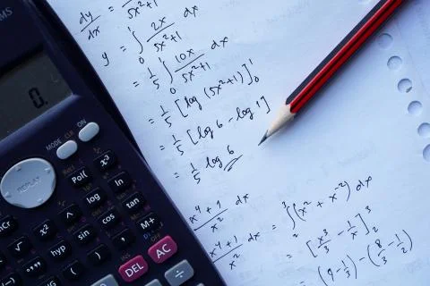 Scientific math workout. sheet paper with solving equation math next to calcu Stock Photos