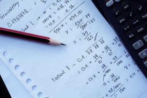 Scientific math workout. sheet paper with solving equation math next to calcu Stock Photos