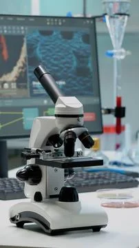 Scientific microscope on laboratory desk with researching instruments Foto stock