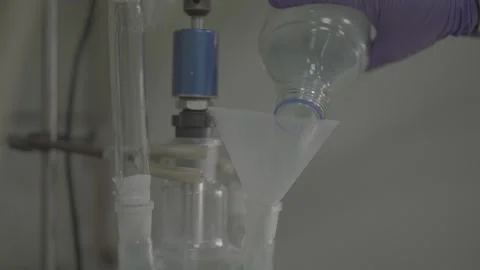 Scientific pouring of chemical solution using a funnel Stock-Footage 327633141