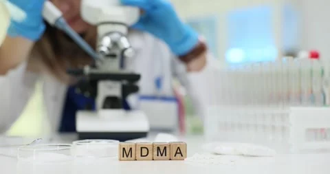 Scientific researcher examines MDMA using microscope in lab Stock Footage 310232531