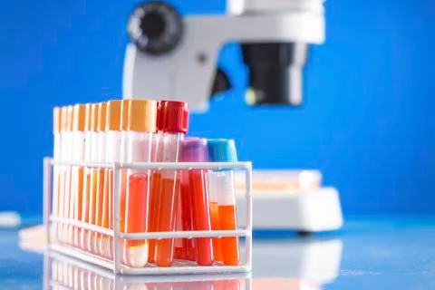 Scientific samples in test tubes with microscope Stock Photos