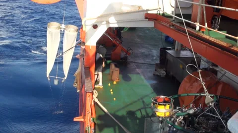 Scientific taking samples of an ocean microorganisms from a Bongo nets Stock Footage 36464962